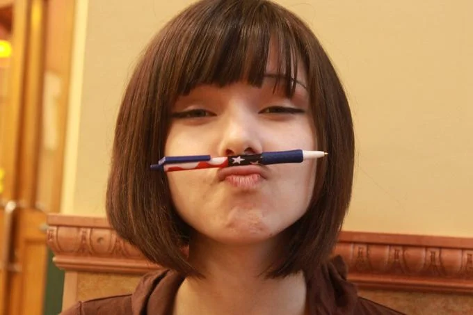 Katya Lischina balancing a pen on her upper lip