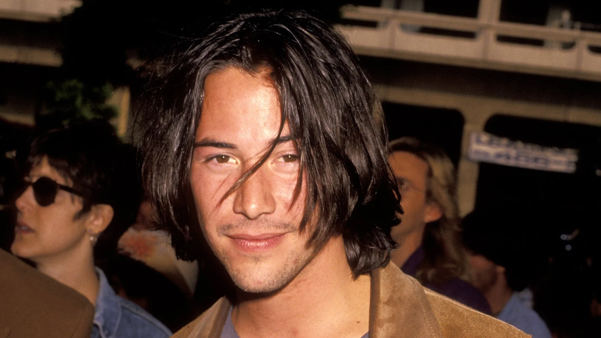 Keanu Reeves Is Such A Gentleman — Young Keanu Reeves with long dark hair and stubble at a public event
