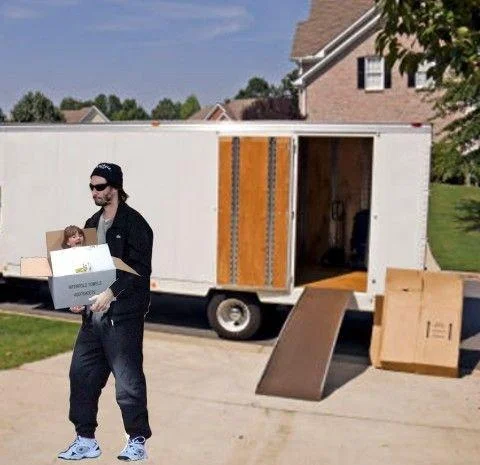 Keanu Reeves — Photoshopped Sad Keanu carrying a box with a small girl inside next to a moving truck
