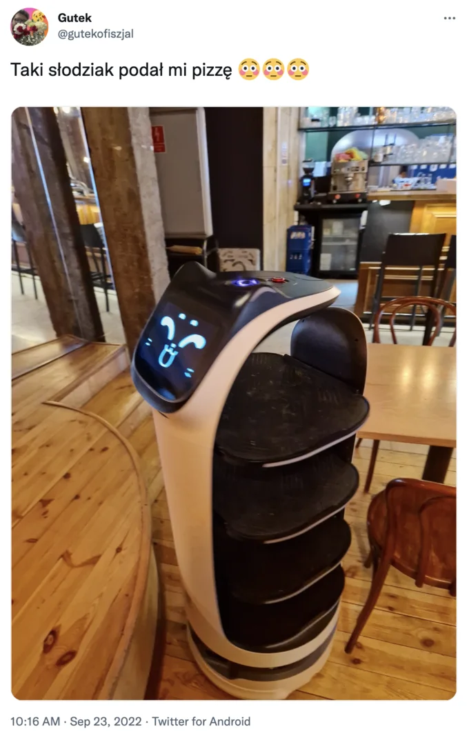 Kerfus — Twitter post in Polish showing a Pudu delivery robot with a sad blue face in a restaurant.