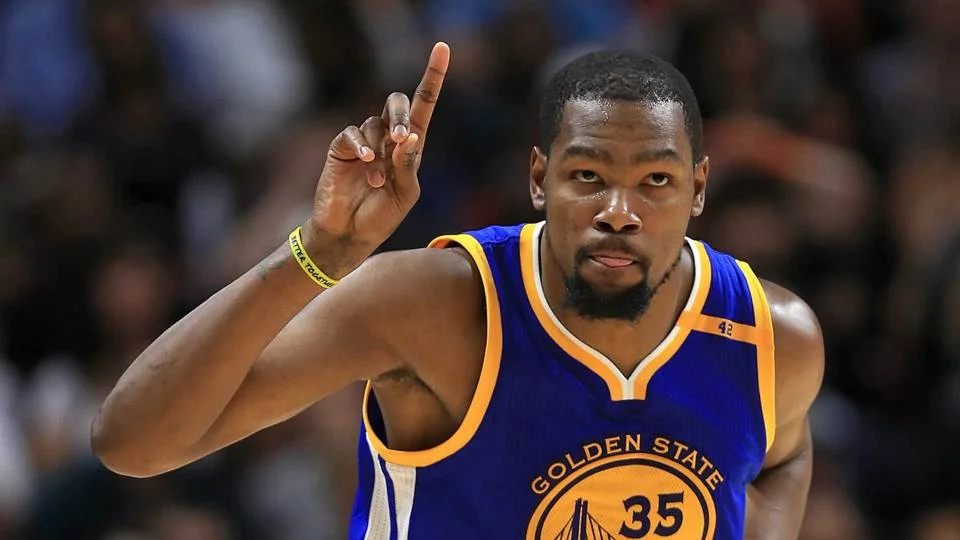 Kevin Durant in Golden State Warriors jersey pointing finger up