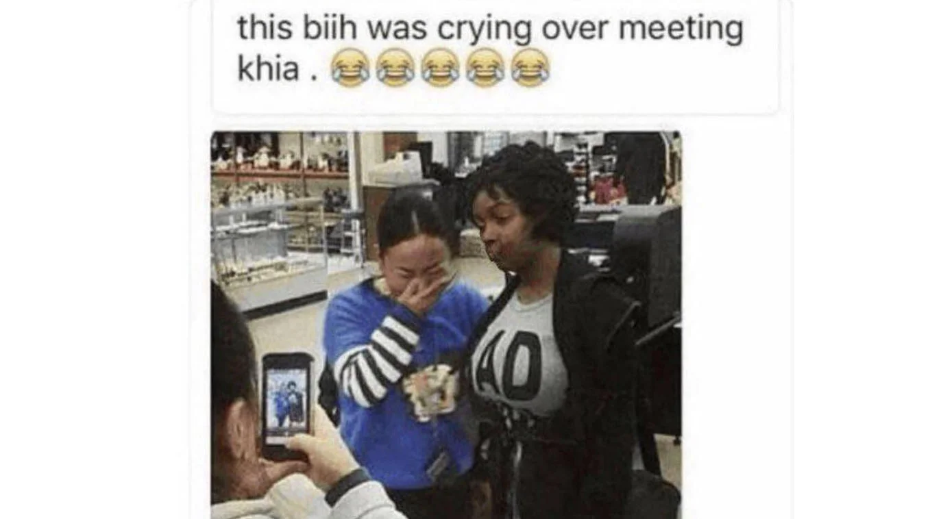 Social media post reading 'this biih was crying over meeting khia' with photo of two women at a store, one covering her face.