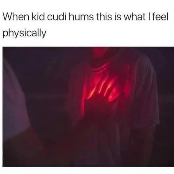 Person's chest glowing red beneath their shirt with Kid Cudi humming caption.