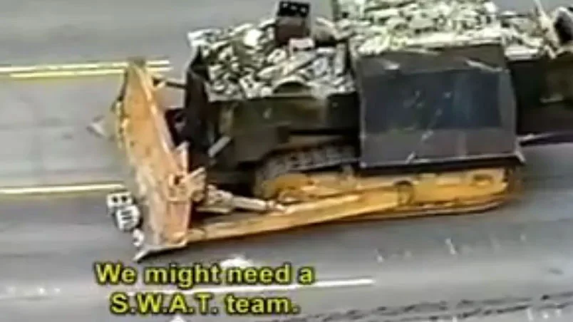 Armored Killdozer bulldozer on a road with subtitle 'We might need a S.W.A.T. team.'