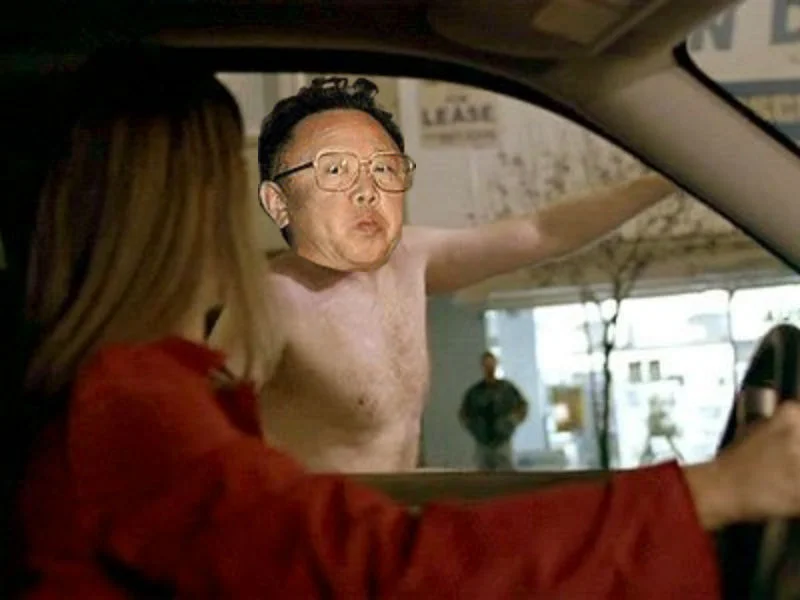 Kim Jong Il Looking At Things — Kim Jong-il's face photoshopped onto a shirtless man leaning into a car
