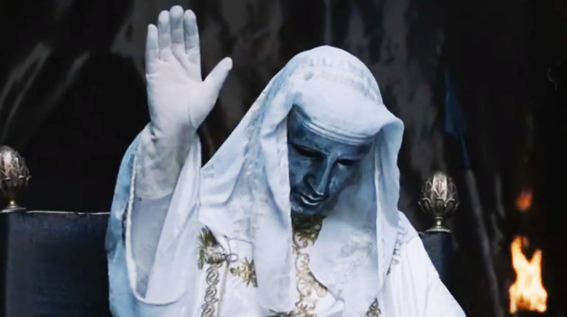 King Baldwin IV Hand Raise — King Baldwin IV in silver mask and white robes raising his gloved hand on his throne