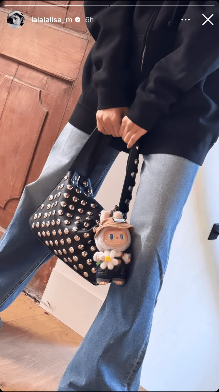 Labubu Toys — Instagram story showing Labubu charm attached to studded handbag