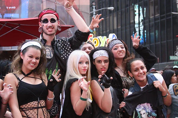 Group of Lady Gaga fans in costume posing on a city street
