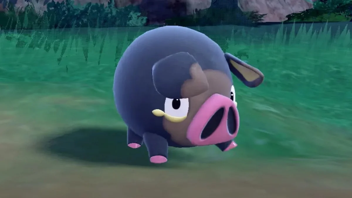 Lechonk the pig Pokémon standing in grass in a Pokémon Scarlet and Violet screenshot
