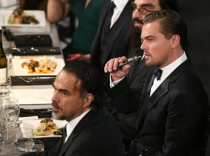 Leonardo DiCaprio vaping at a black-tie awards dinner