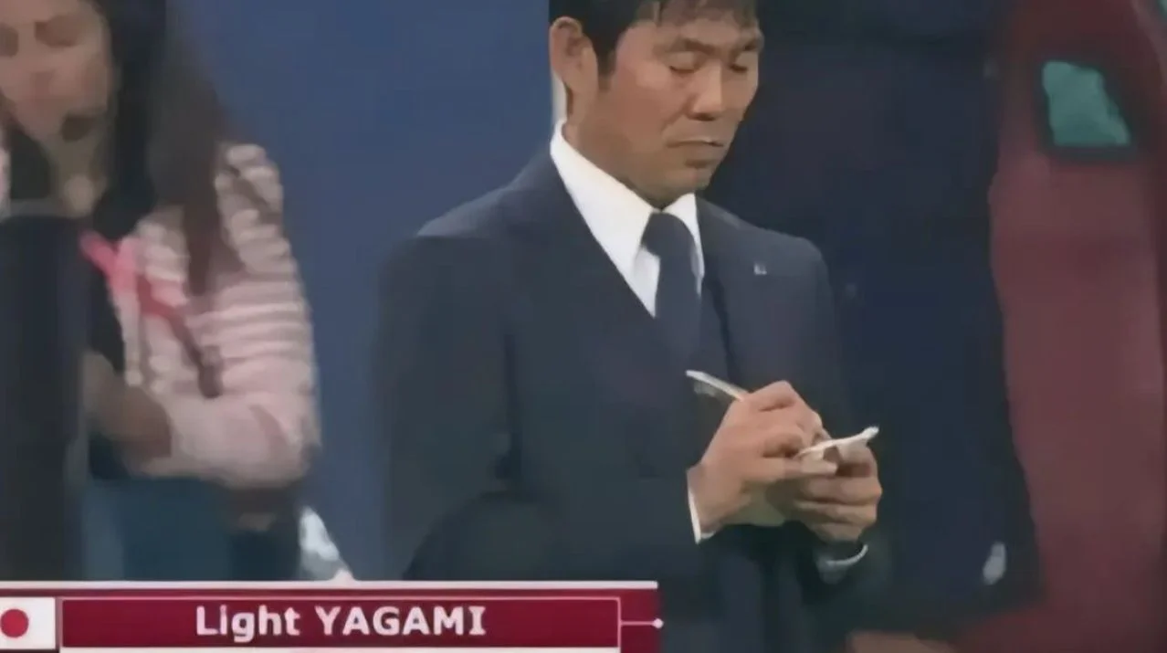Light Yagami At The Olympics — Japanese coach writing in notebook with broadcast nameplate reading Light YAGAMI