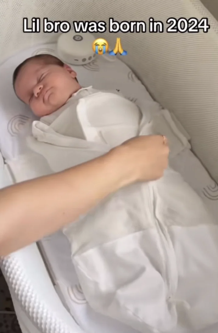 TikTok screenshot of adult tucking in sleeping newborn with 'Lil bro was born in 2024' caption