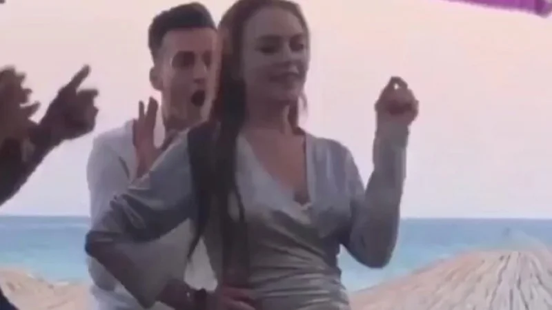 Lindsay Lohan Beach House Dance — Lindsay Lohan doing an awkward shuffle dance in a silver dress at her Mykonos beach club