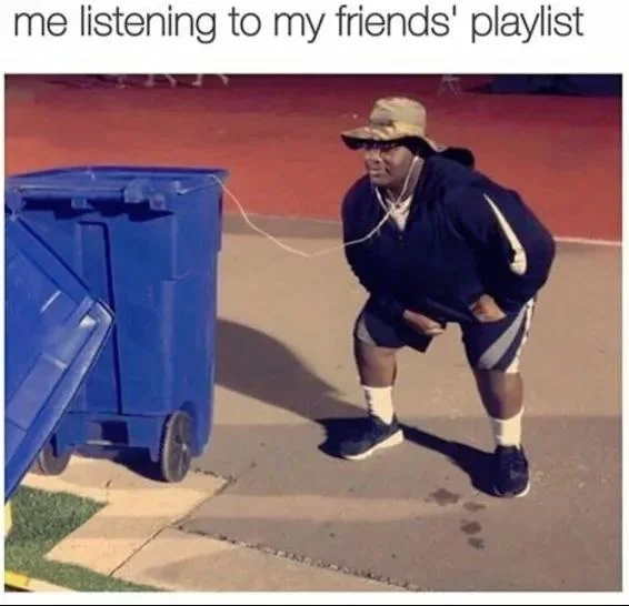 Listening to Trash — Vertical uncropped source photo of man leaning toward blue trash bin with earbuds at nighttime track meet