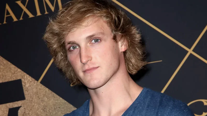 Logan Paul portrait at a Maxim event with blonde hair and blue shirt