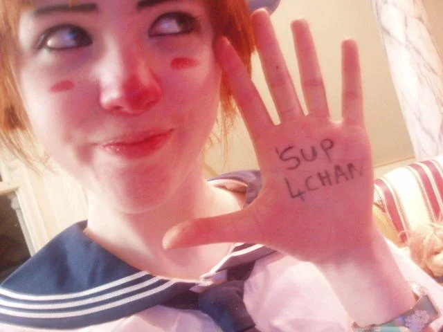 Loli-chan — Cosplayer with painted cheeks showing 'Sup 4chan' written on her hand