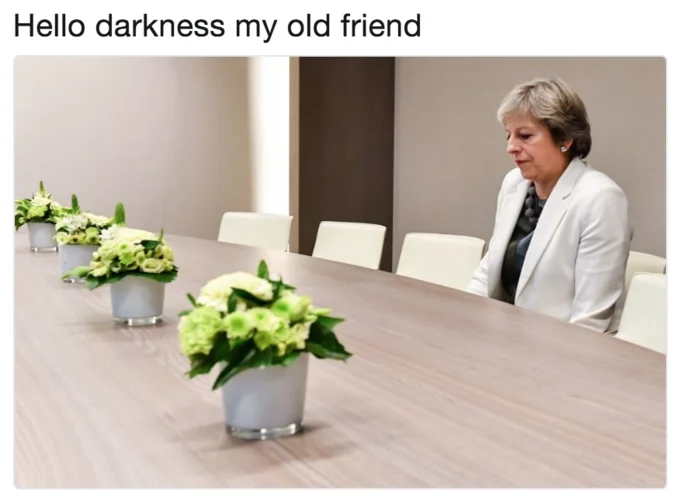 Lonely Theresa May — Theresa May alone at conference table with caption 'Hello darkness my old friend'.