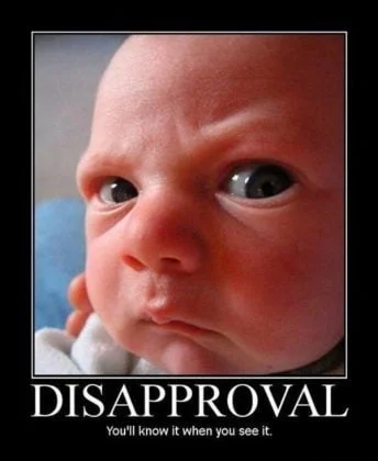 Look of Disapproval — Angry baby with disapproving facial expression and text overlay reading DISAPPROVAL