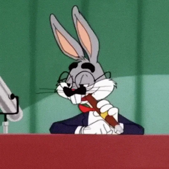 Looney Tunes — Bugs Bunny in tuxedo and fake mustache standing at a podium with a microphone.