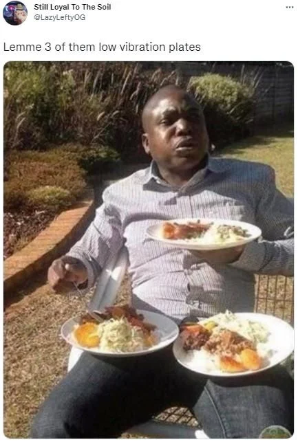 Tweet showing a man seated outside with three plates of food, captioned 'Lemme 3 of them low vibration plates'.