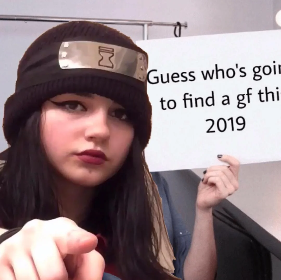 Lucifersexdoll — Girl in Naruto headband pointing at camera holding sign about finding a girlfriend in 2019