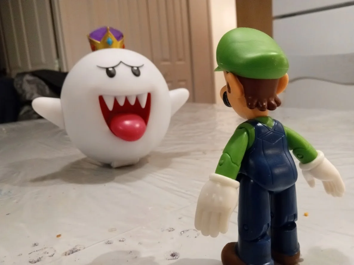 Luigi and King Boo action figures posed together on a table