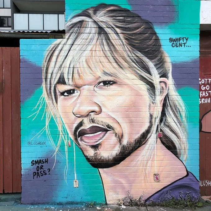 Lushsux mural portrait of rapper 50 Cent on a red brick wall