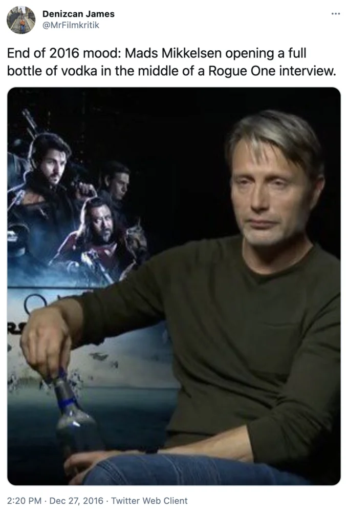 Mads Mikkelsen Opening Vodka During Interview — Twitter post by Denizcan James with caption 'End of 2016 mood' showing Mads Mikkelsen holding a drink during
