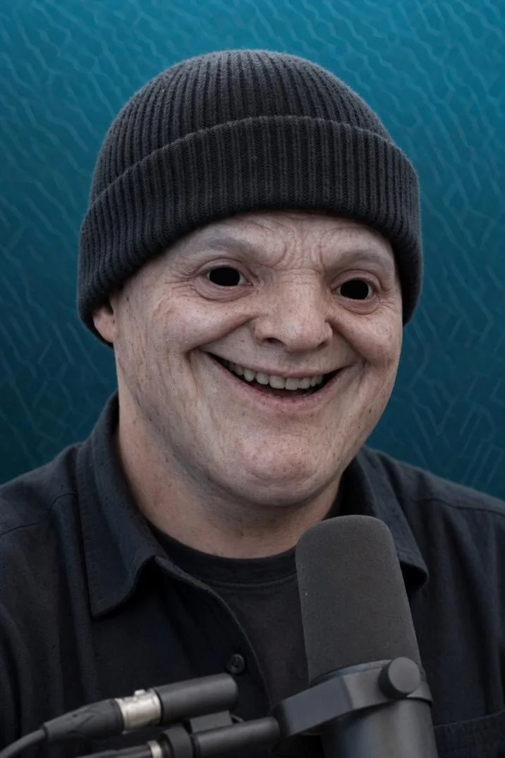 MAGA Wojak — AI-generated magatard character wearing a black beanie in front of a podcast microphone