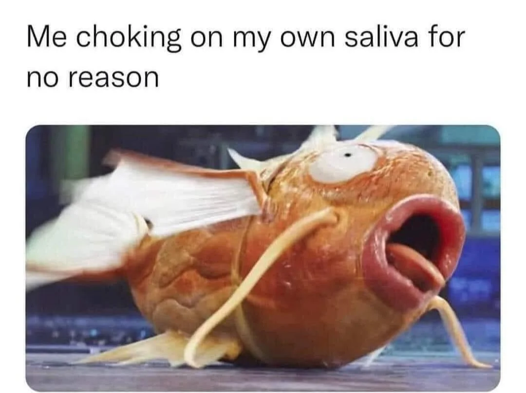 Meme image of a lifelike Magikarp model with mouth wide open, captioned about choking on saliva.
