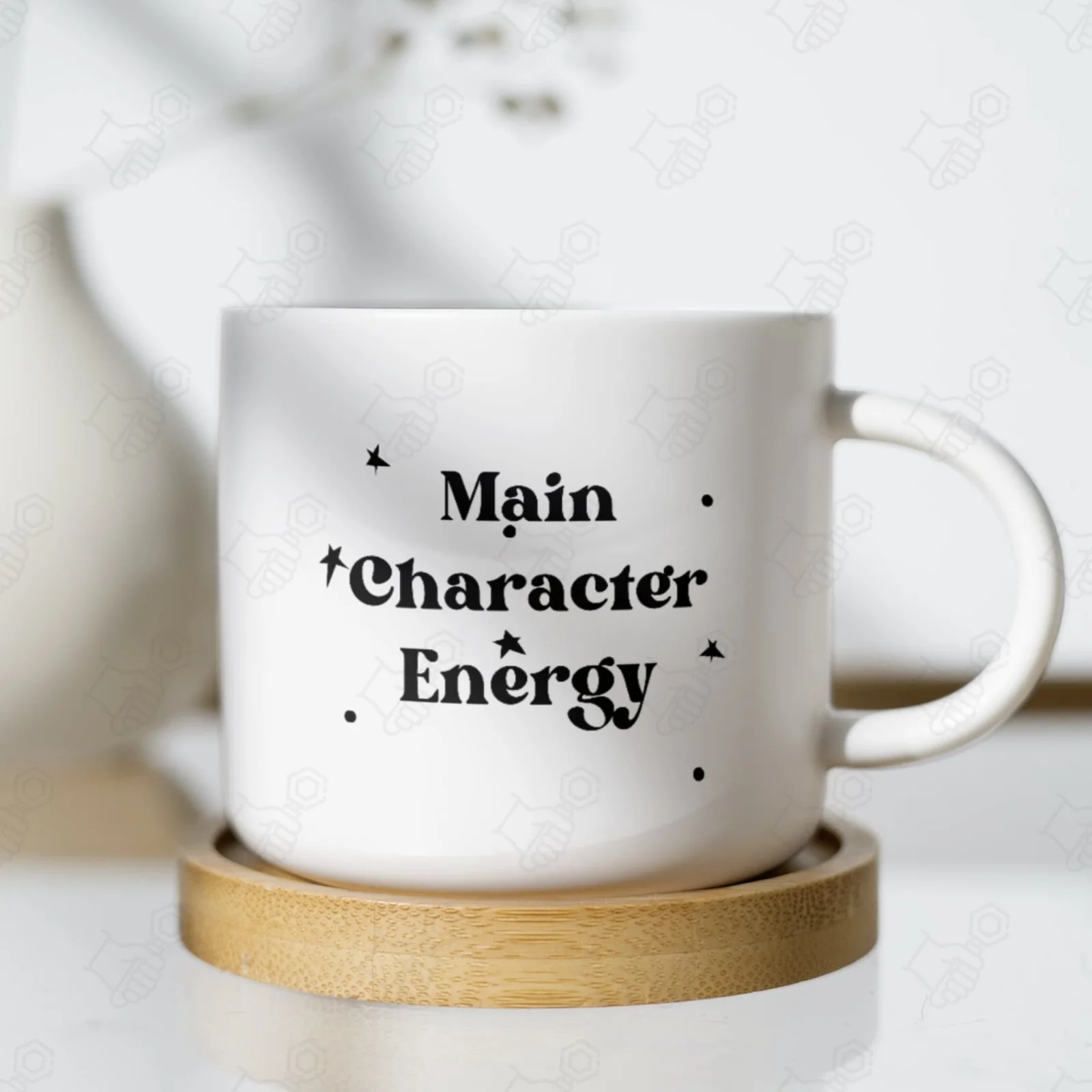 White mug printed with 'Main Character Energy' text with decorative stars and dots