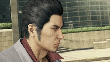 Majima Everywhere — A close-up animated GIF frame of Kazuma Kiryu in profile, expression tense and watchful against an urban Kamurocho backdrop.