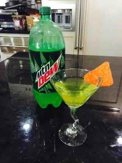 Major League Gaming — Mountain Dew bottle next to green cocktail garnished with a Dorito