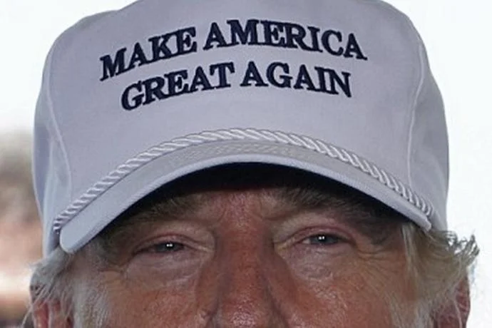 Make America Great Again — Close-up of Donald Trump wearing a white MAGA hat with embroidered slogan