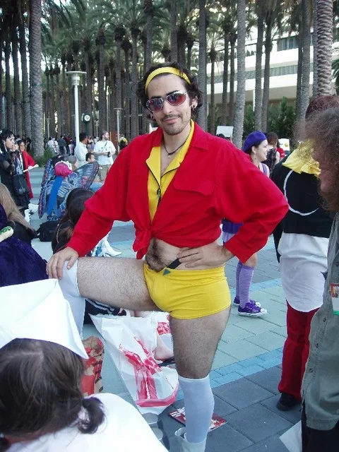 Man-Faye dancing with arms raised at anime convention crowd