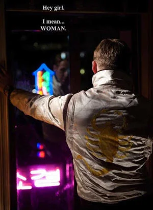 Mansplaining — A man in light jacket gesturing with text 'Hey girl.' / 'I mean... WOMAN.' depicting overly careful condescending correction.