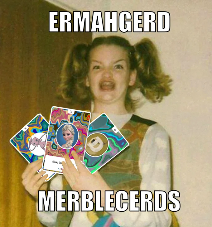 MarbleCards — A woman from Clueless holds colorful digital trading cards with 'ERMAHGERD' and 'MERBLECERDS' text overlays, featuring psychedelic patterns and