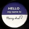 A blue and white 'Hello My Name Is' adhesive name tag sticker with 'Mary Sue' written in the name field.