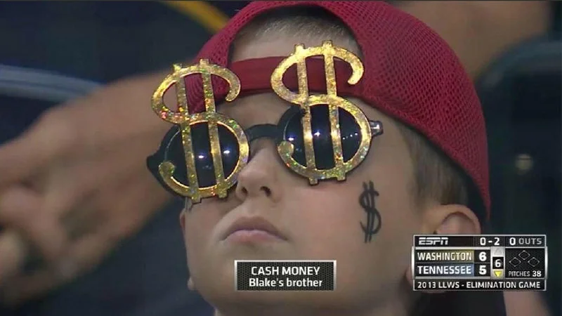Me Irl — ESPN sports broadcast screenshot of young boy wearing oversized dollar sign novelty glasses identified as 'CASH MONEY Blake's brother'.