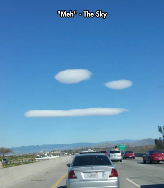 Meh. — Highway sky with clouds forming an unimpressed face, captioned 'Meh - The Sky'.