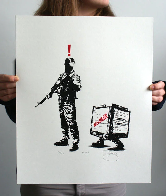 Metal Gear Solid Enemy Alert — Stencil-style art print in black silhouette showing an armed soldier in tactical gear with a red exclamation mark above.