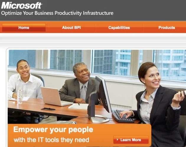 Original Microsoft business ad showing three diverse coworkers around a computer