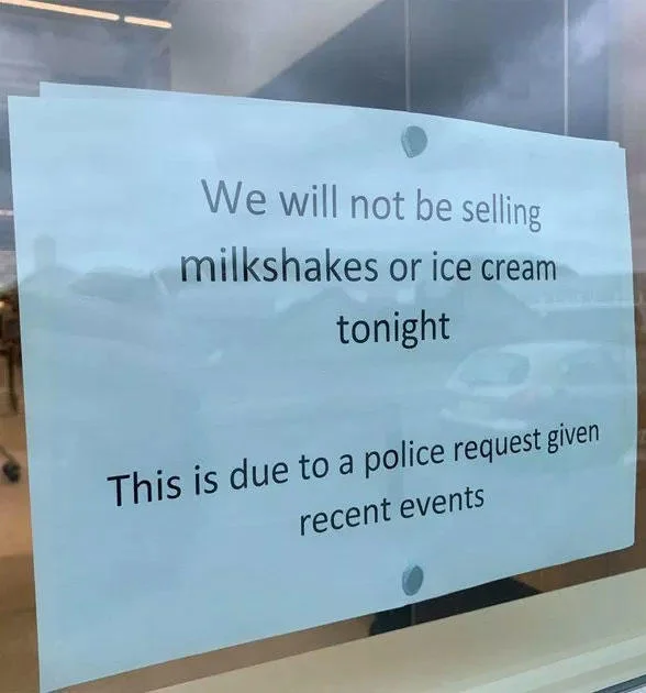 Milkshaking — Blue sign posted in business window announcing no milkshakes or ice cream sold due to police request following incidents.