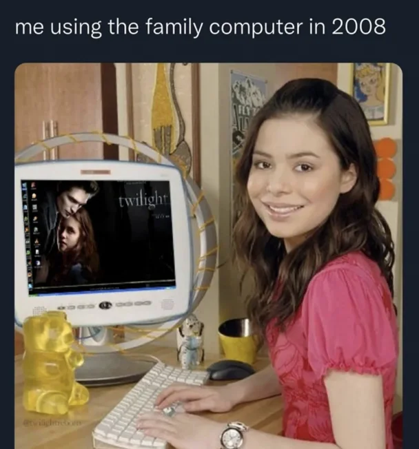 Millennial Pink Nostalgia — Girl at desktop computer displaying Twilight, surrounded by early 2000s bedroom décor and tech accessories.