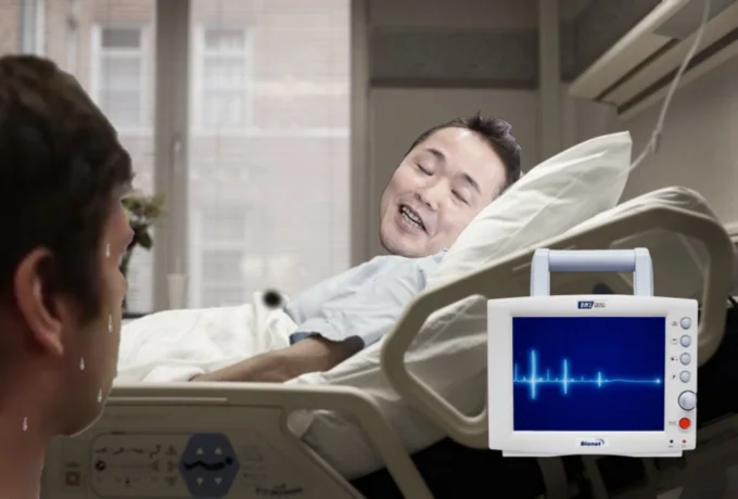 MISTAH MERRIKU — Smiling Masuda-faced patient lying in a hospital bed as a nervous man watches
