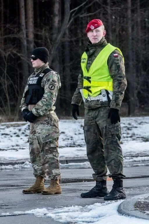Mogging — Two military personnel in tactical gear, significant height difference