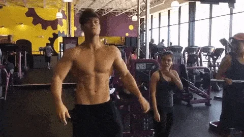 Mogging — Muscular man displaying physique in gym setting