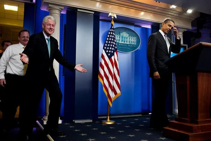 Monica Lewinsky Scandal — Bill Clinton gesturing at the White House podium next to Barack Obama