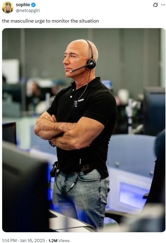 Monitoring The Situation — Man in black polo shirt and headset standing with arms crossed in confident watchful stance.