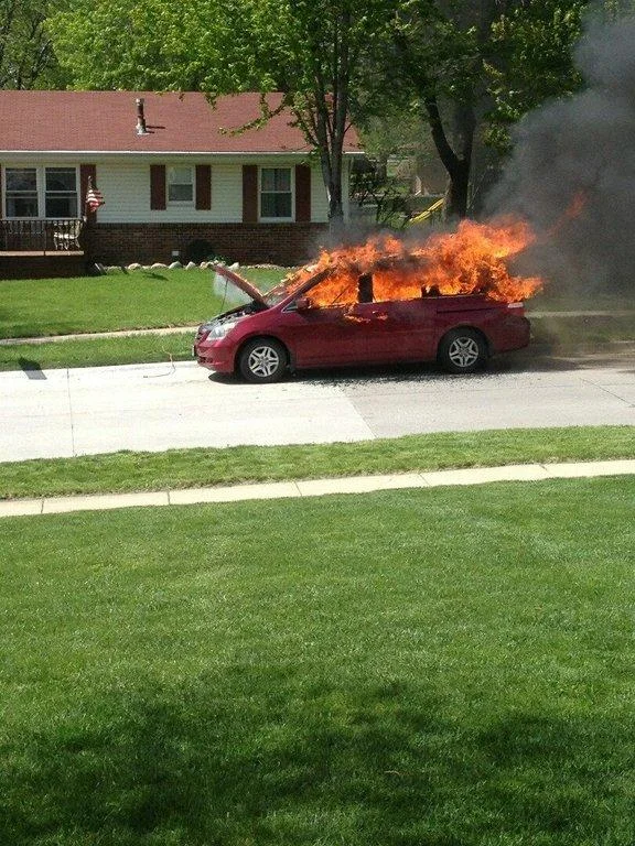 Moose Family in Kiddie Pool Watching Car Fire — Red minivan on fire in a suburban street